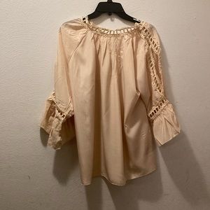 Women’s cream colored top with lace accents and lace cut out on arms.